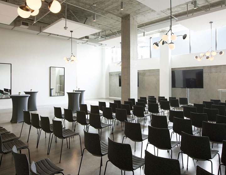 Chairs and tables arranged in a theatre set up in Beachwood Ballroom at Kimpton Everly