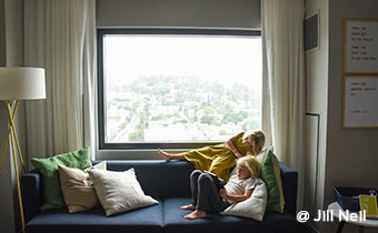 Brother and Sister lounging on couch in Everly Suite